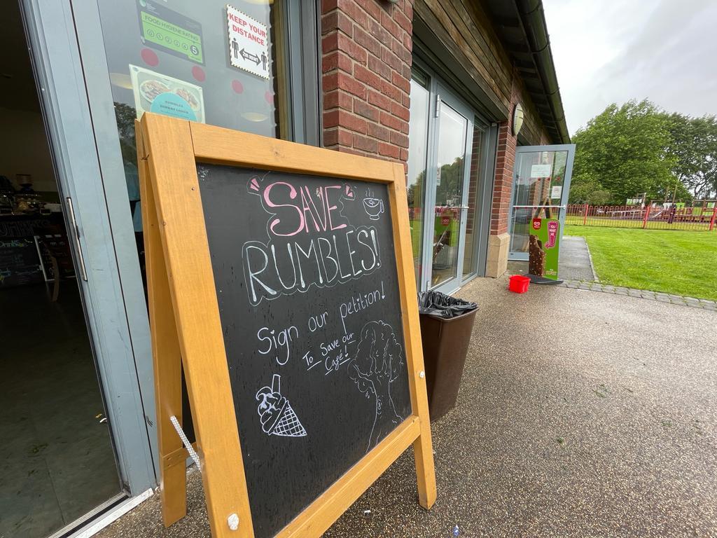 A board at Rumbles Cafe urging the public to safe the charity from closure
