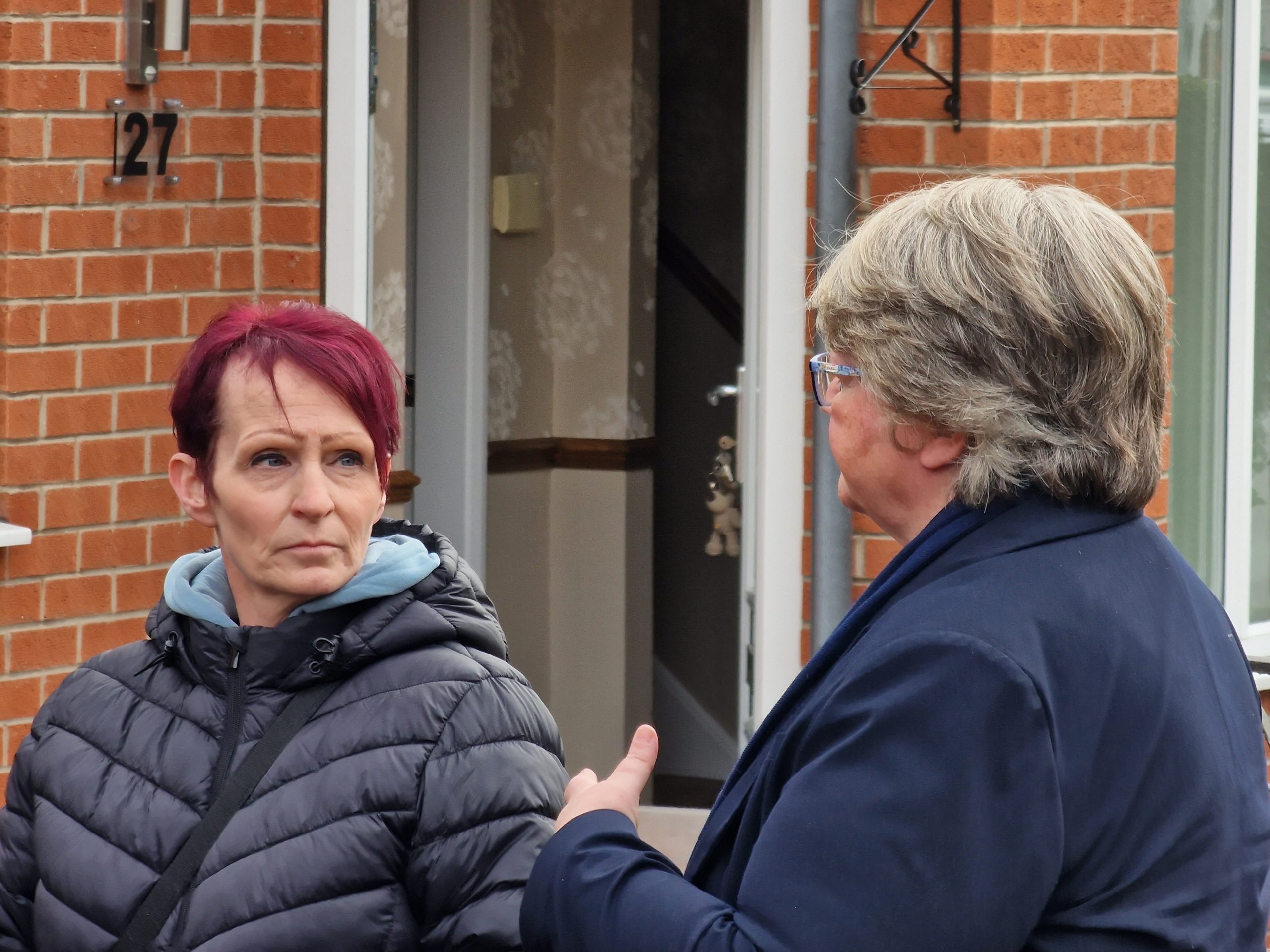 Environment Secretary Therese Coffey right speaks to Darrel Road resident Lucy Rose scaled