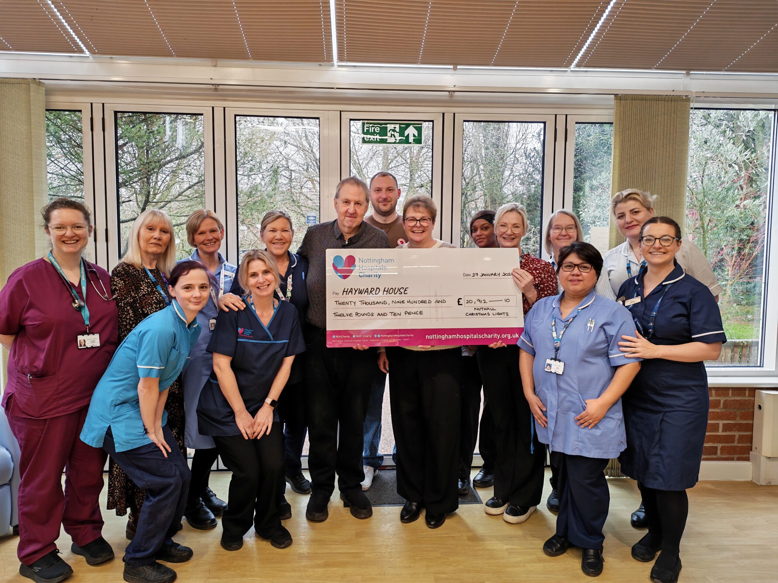 Nottingham family raises £300,000 with annual Christmas lights The Swift family presenting their final cheque scaled